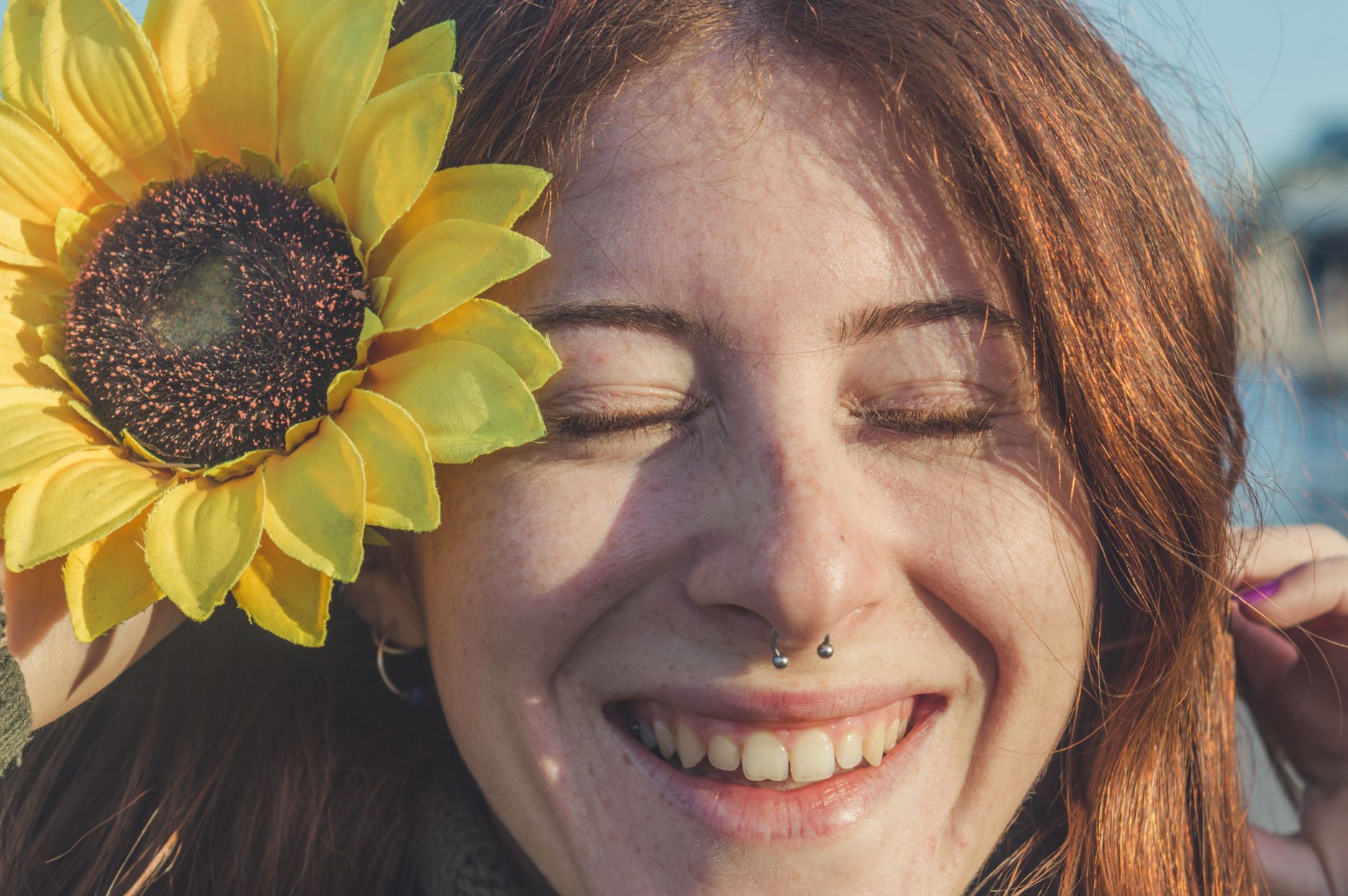 Jeune femme souriante portant un piercing septum au nez